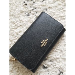 Coach flap phone wrislet wallet in black and gold